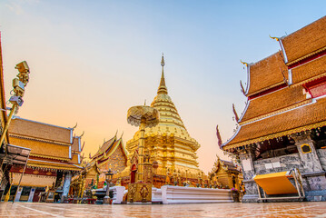 Wat Phra That Doi Suthep with golden morning sky, the most famous temple in Chiang Mai, Thailand (Low angle view) - Powered by Adobe