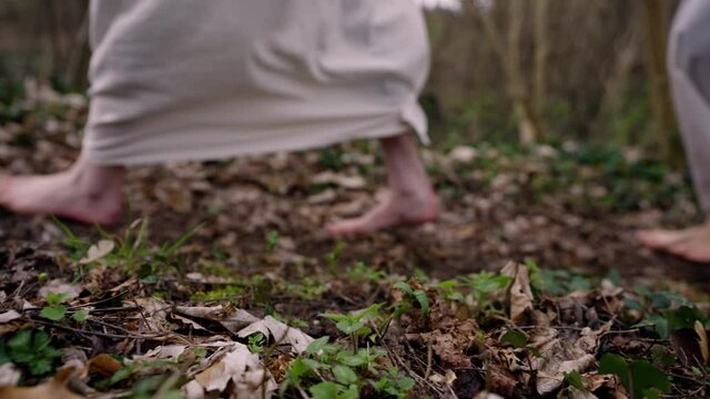 parallel shot of the feet of Mary Magdalena, Mary Mother of James and Salome on their way to the grave of Jesus to embalm him.