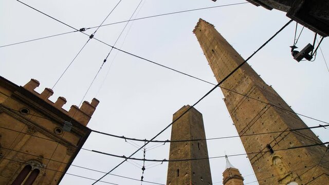 Torre degli Asinelli towers in city center of Bologna, Emilia Romagna, Italy. Famous landmark and tourist attraction in the northern Italian town during the day. 4K.