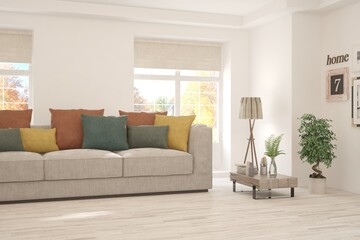 Fototapeta premium Stylish room in white color with sofa and autumn landscape in window. Scandinavian interior design. 3D illustration