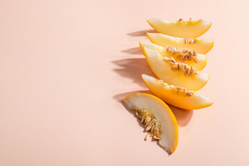 Creative outline with slices of ripe melon on a beige background. Food concept. Fruit isolated on background. Food ingredients template