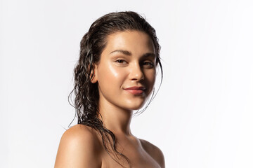 Beautiful young woman with clean perfect glowing skin, wet hairs. Portrait of smiling girl with...