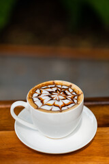 hot latte art coffee on wood table, relax time