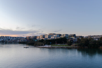 Fototapeta na wymiar Sunset view of Meadowbank and Ryde from Parramatta River waterfront.