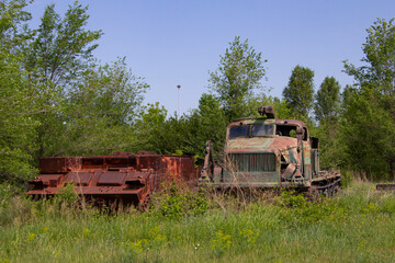 Fototapeta premium Old Soviet military equipment in the forest. Heavy military equipment abandoned in the forest.