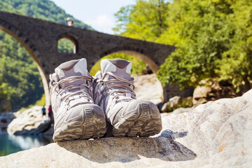 Hiking Boots on a River Background 