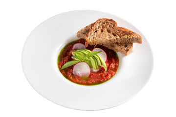 traditional Spanish tomato soup. cold mashed soup with radishes, avocado and toasted slices of bread. gazpacho. isolated on white.