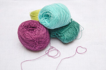 skeins of thread on a white background, multicolored skeins of thread for needlework, skeins of...