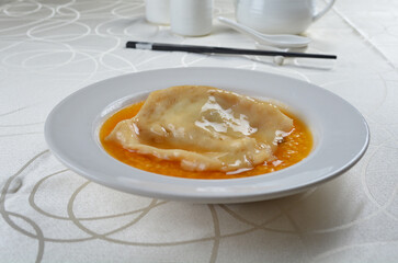 braised fresh premium fish maw seafood in Chinese herbal wine sauce in white background asian halal menu