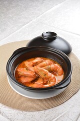 braised cook big fresh tiger prawn with red spicy curry soup in hot clay pot asian halal seafood menu