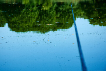 Fishing rods and spinnings in the composition with accessories for fishing on the river