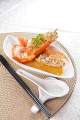 poached big fresh tiger prawn seafood with chinese herb and wine sauce in white background asian halal menu