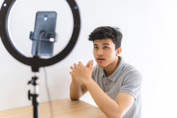 A man is creating content using a ring light