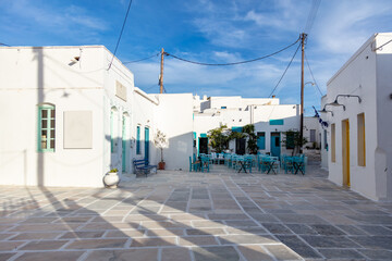 Fototapeta na wymiar Serifos island, Chora, Cyclades Greece. Open empty cafe tavern chairs tables background.