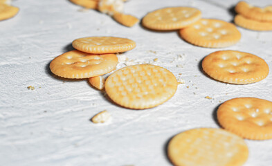 An image selected focus circle crackers or snack or biscuits treat gourmet or junk food falling and cracking on the ground.