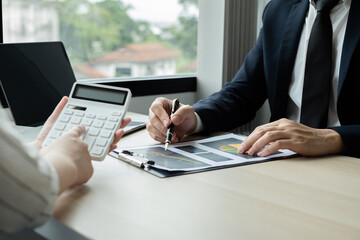 Two business leaders talk about charts, financial graphs showing results are analyzing and calculating planning strategies, business success building processes