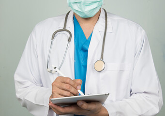 Medicine doctor working with his digital tablet in the hospital. medical staff in uniform