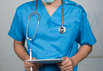 Medicine doctor working with his digital tablet in the hospital. medical staff in uniform