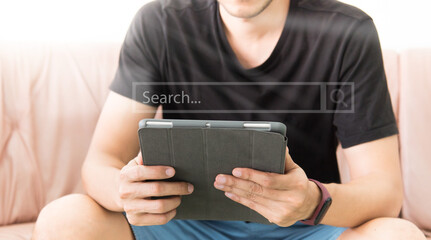 man using digital tablet while relaxing on sofa. Concept of young business people working at home