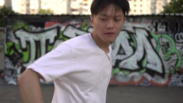 Young modern asian male street dancer. Asian man dancing breakdance or hip hop on the street