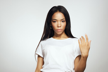 woman of african appearance with long hair in white t-shirt cosmetics