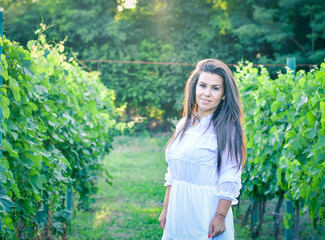 Young beautiful smiling woman   walking at Vineyard Wine tourism