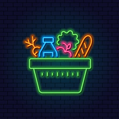 Neon Grocery Cart. Basket with vegetables, fruits, milk and bread. Concept for Grocery Store, Consumer Basket. Glowing neon sign on a dark background.