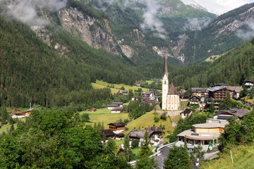Fototapeta premium Heiligenblut with St. Vincent Church in front of the Hohe Tauern mountains. Carinthia. Austria