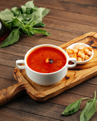 Russian soup solyanka with smoked meats and croutons