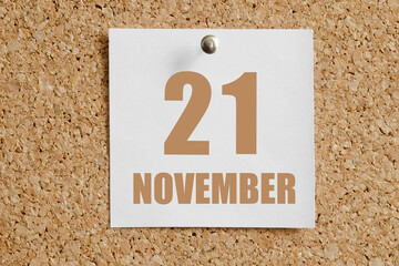 november 21. 21th day of the month, calendar date.White calendar sheet attached to brown cork board.Autumn month, day of the year concept