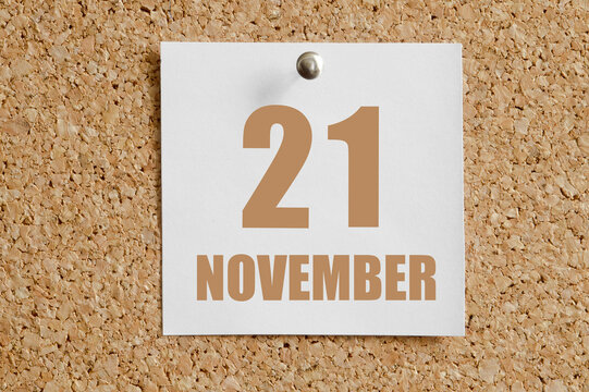 november 21. 21th day of the month, calendar date.White calendar sheet attached to brown cork board.Autumn month, day of the year concept