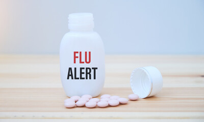 Fototapeta na wymiar Flu text alert on white glass jar. Flu season concept.