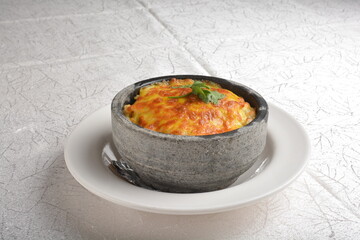 baked cheese creamy seafood meat fried rice in stone bowl in white background asian halal menu