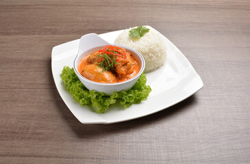 cook braised nonya red curry chicken serve with steamed jasmine white rice main course in wood background asian halal menu