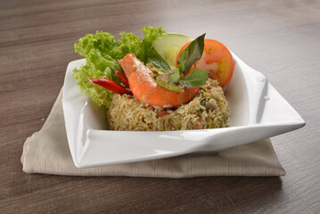 stir fried egg rice with seafood tiger prawn in thai green curry sauce in wood background asian halal menu