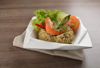 stir fried egg rice with seafood tiger prawn in thai green curry sauce in wood background asian halal menu