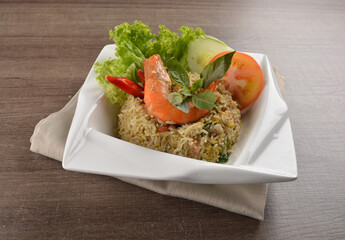 stir fried egg rice with seafood tiger prawn in thai green curry sauce in wood background asian halal menu