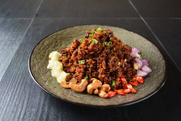 vegan healthy olive fried rice with mixed nut and onion chilli in black background asian halal menu