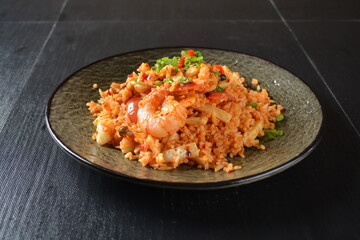 thai style spicy chilli tom yum dry fried egg rice with seafood prawn and meat in black background asian halal menu