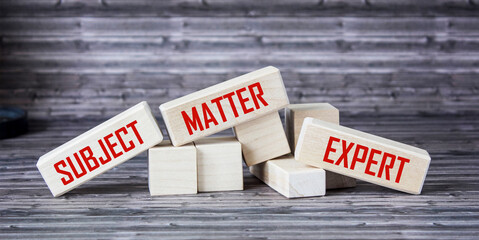 Naklejka premium On wooden blocks the inscriptions SUBJECT, MATTER, EXPERT. Business concept
