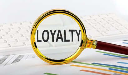 Magnifying glass with the word LOYALTY on the chart background