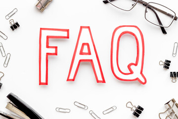 Word faq frequently asked questions with stationery on working place
