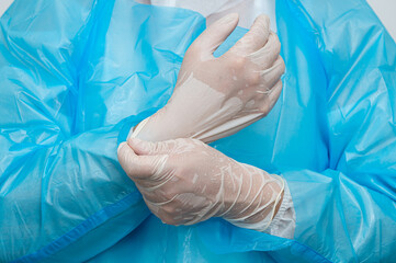 A medical worker wearing sweaty gloves in the heat.