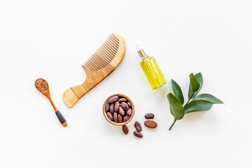 Hair treatment by cocoa oil with hair comb. Top view