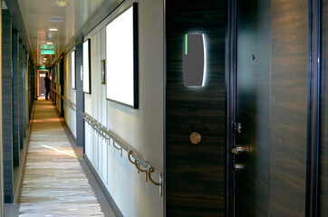 Corridor or aisle to cabins, staterooms or suites on modern luxury Norwegian cruise ship or...