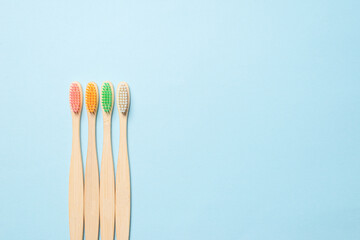 Bamboo toothbrush on a blue background.