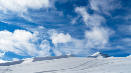 The image of snowboarders on a snowy mountain top.