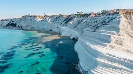 Scala dei Turchi,Sicily,Italy.Aerial view of white rocky cliffs,turquoise clear water.Sicilian seaside tourism,popular tourist attraction.Limestone rock formation on coast.Travel holiday scenery.