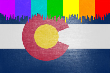 Paint (rainbow flag) is dripping over the state flag of Colorado