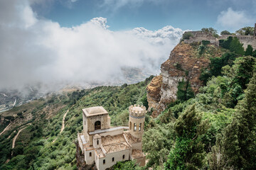 Erice,Sicily,Italy.Historic town on the top of mountains overlooking beautiful lush countryside.View of Venus Castle,Castello di Venere, in clouds.Breathtaking panorama.Misty landscape copy space - obrazy, fototapety, plakaty